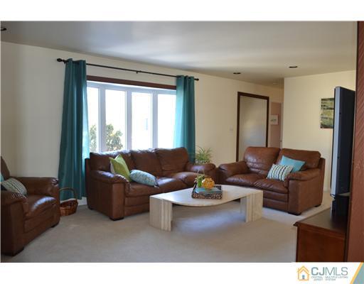 9 Dorian Road Metuchen, NJ 08840 - Photo 2 of 25 a living room with furniture and a large window