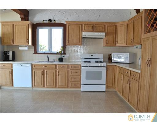 9 Dorian Road Metuchen, NJ 08840 - Photo 12 of 25 a kitchen with stainless steel appliances a stove top oven