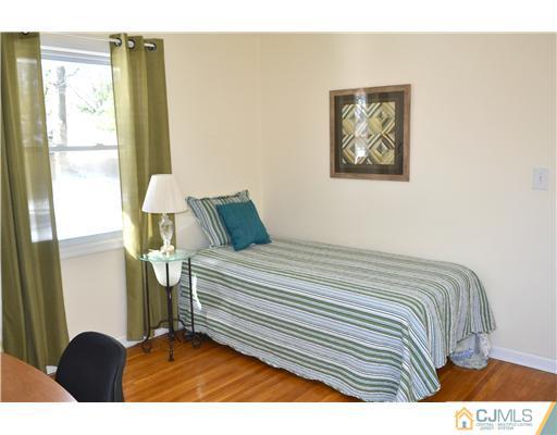 9 Dorian Road Metuchen, NJ 08840 - Photo 17 of 25 a bedroom with a bed and a window