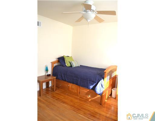 9 Dorian Road Metuchen, NJ 08840 - Photo 18 of 25 a bedroom with a bed and a chandelier