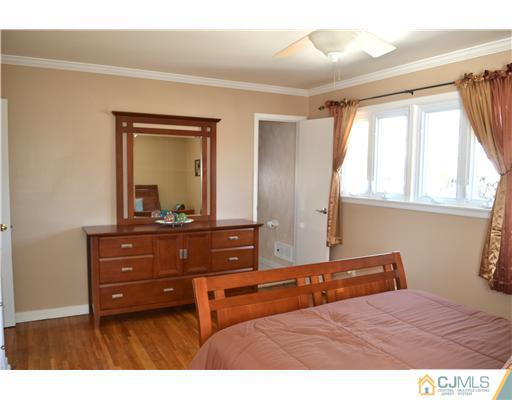 9 Dorian Road Metuchen, NJ 08840 - Photo 21 of 25 a bedroom with a bed and a mirror on dresser