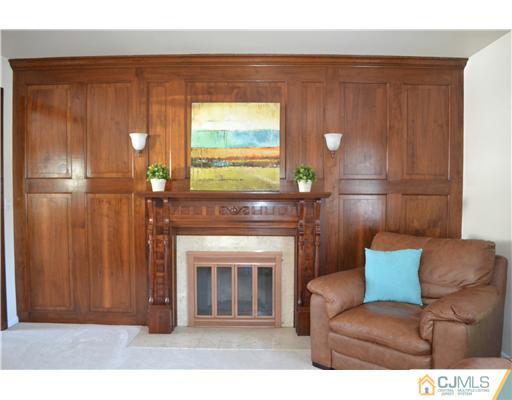 9 Dorian Road Metuchen, NJ 08840 - Photo 4 of 25 a living room with furniture and a fireplace