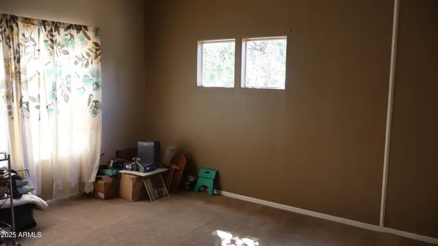 a view of room with window and furniture