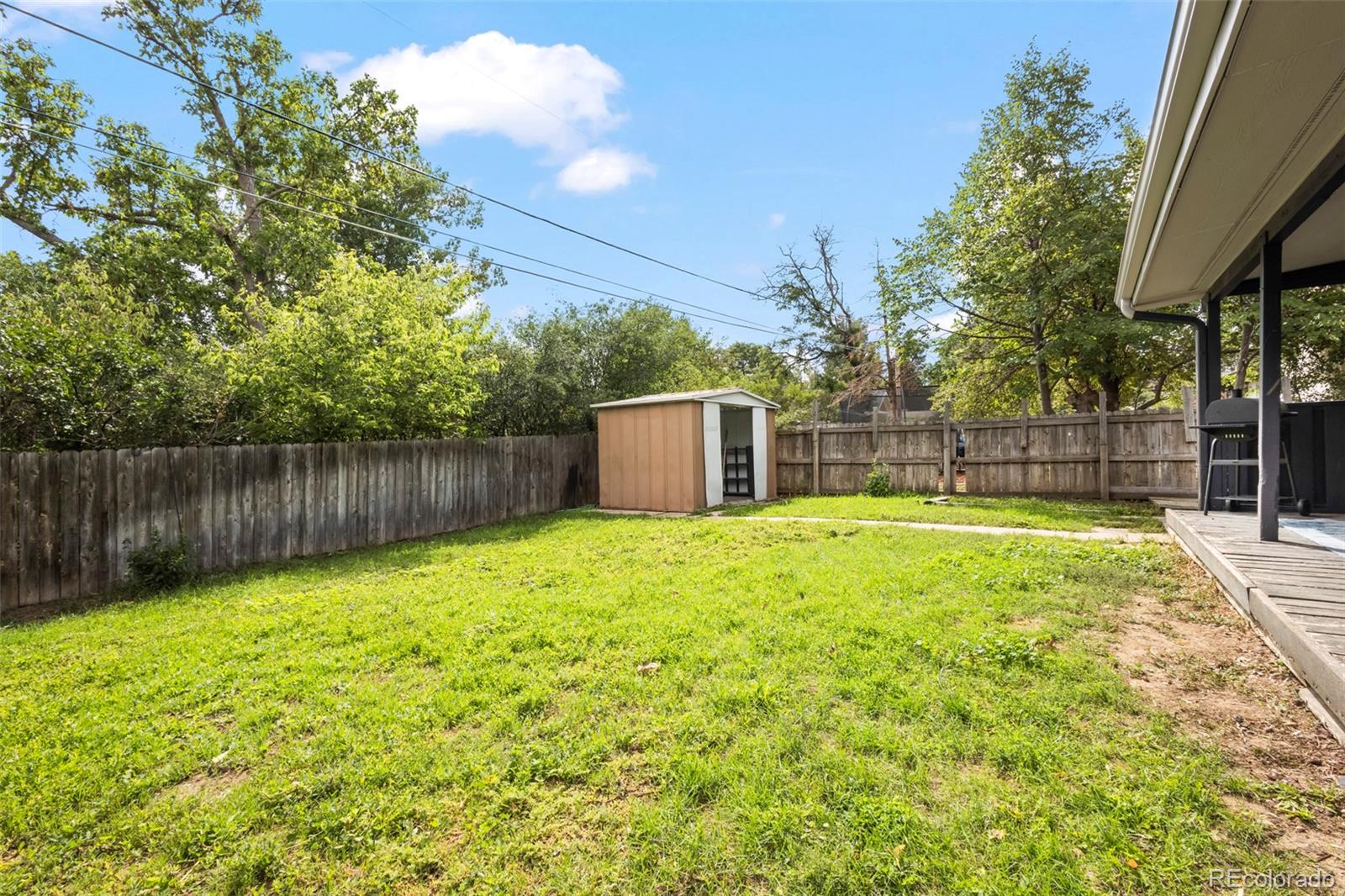 390 Scranton Street Aurora, CO 80011 - Photo 11 of 45 a view of a backyard with a small cabin