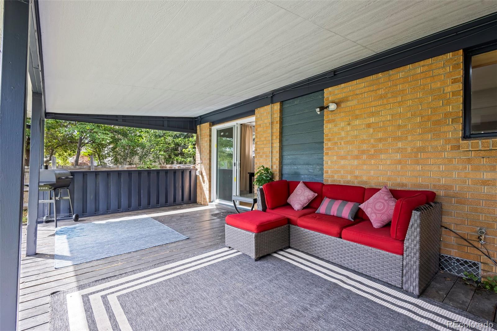 390 Scranton Street Aurora, CO 80011 - Photo 13 of 45 a living room with furniture and a large window