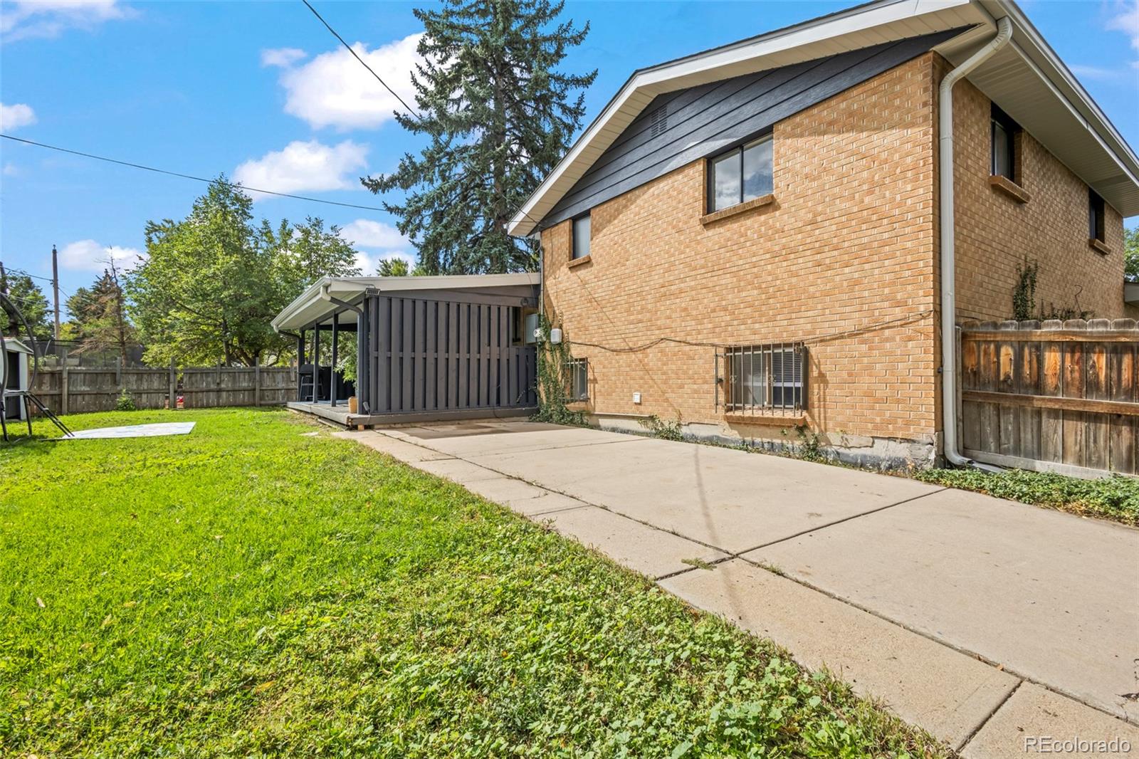 390 Scranton Street Aurora, CO 80011 - Photo 19 of 45 a front view of a house with a yard