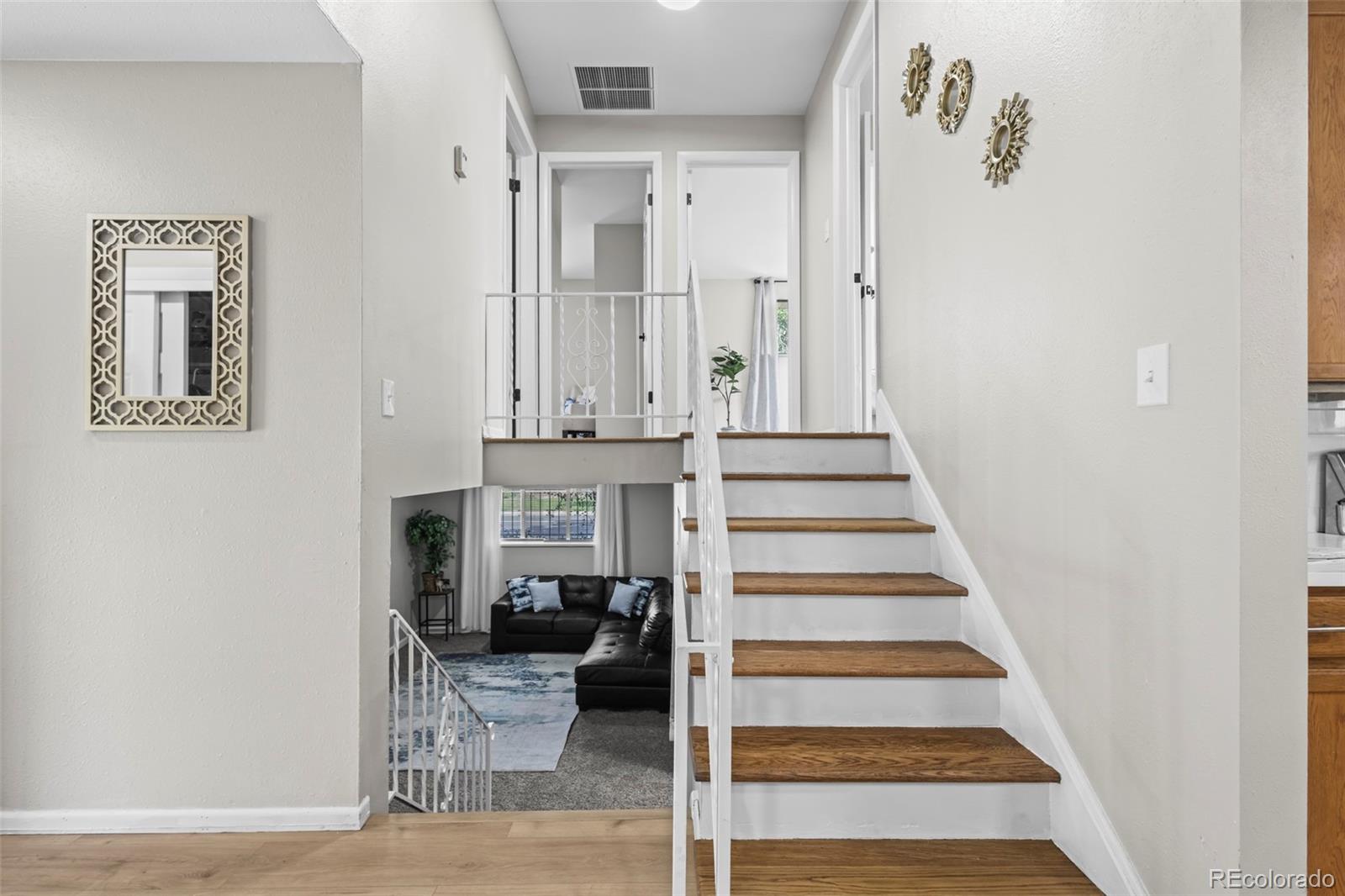 390 Scranton Street Aurora, CO 80011 - Photo 20 of 45 a view of entryway and hall with wooden floor