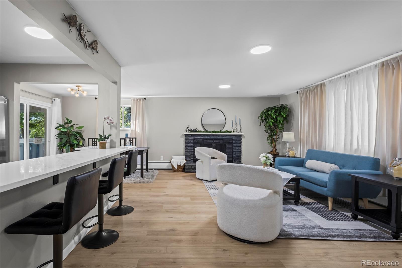 390 Scranton Street Aurora, CO 80011 - Photo 21 of 45 a living room with furniture and a fireplace