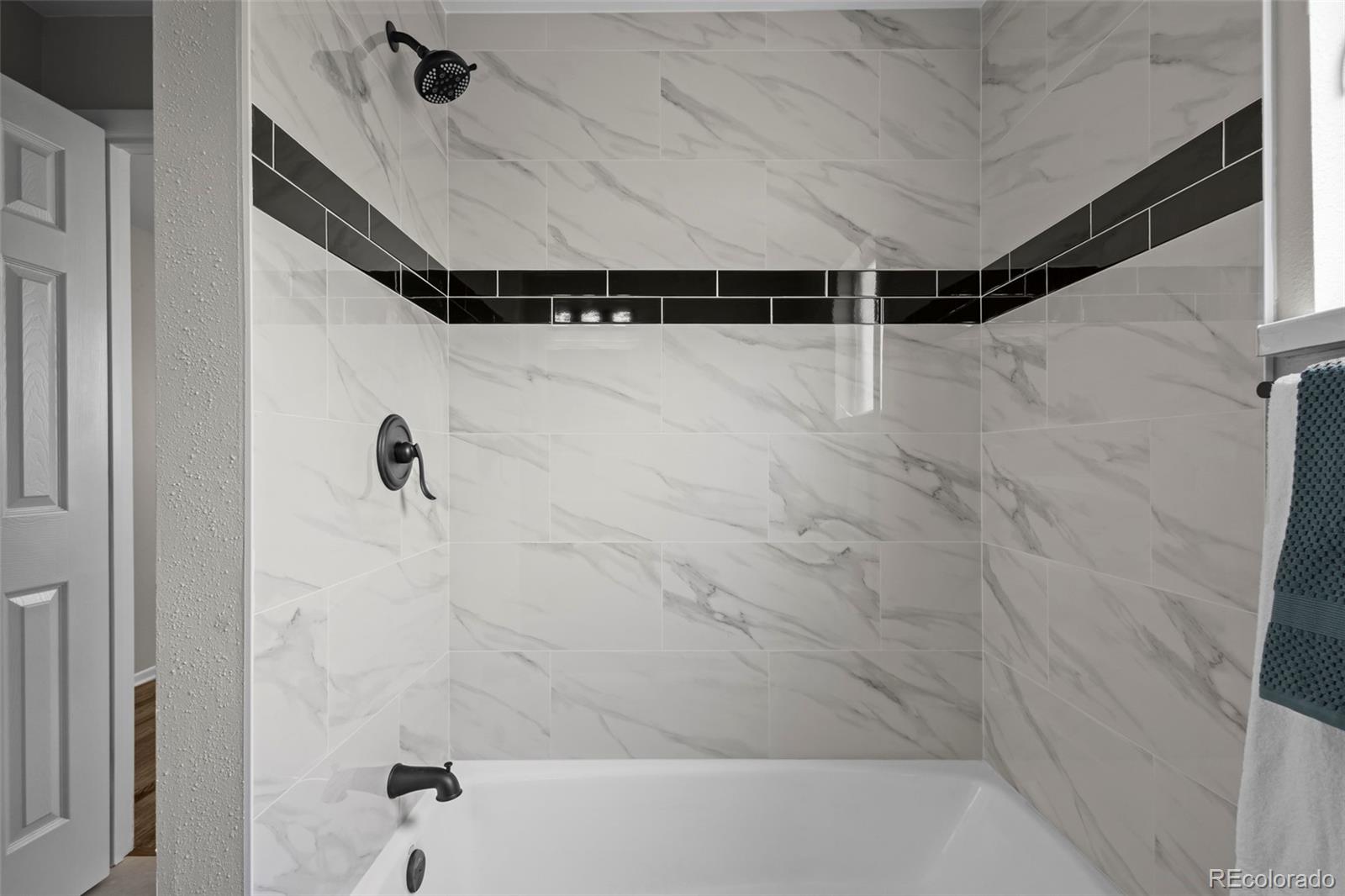 390 Scranton Street Aurora, CO 80011 - Photo 22 of 45 a bathroom with a shower and a shower view