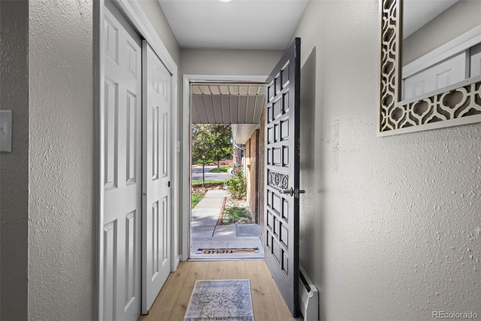 390 Scranton Street Aurora, CO 80011 - Photo 24 of 45 a view of a hallway with a outdoor space