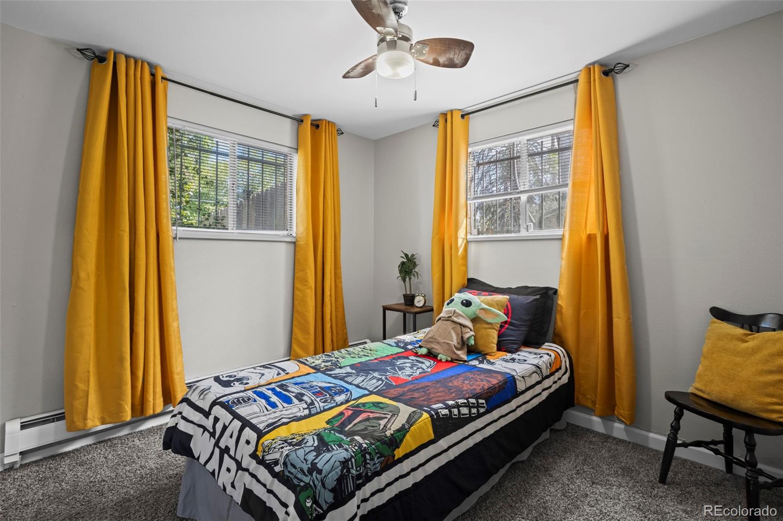 390 Scranton Street Aurora, CO 80011 - Photo 28 of 45 a bedroom with a bed and wooden floor