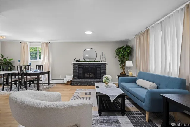 a living room with furniture a fireplace and a window