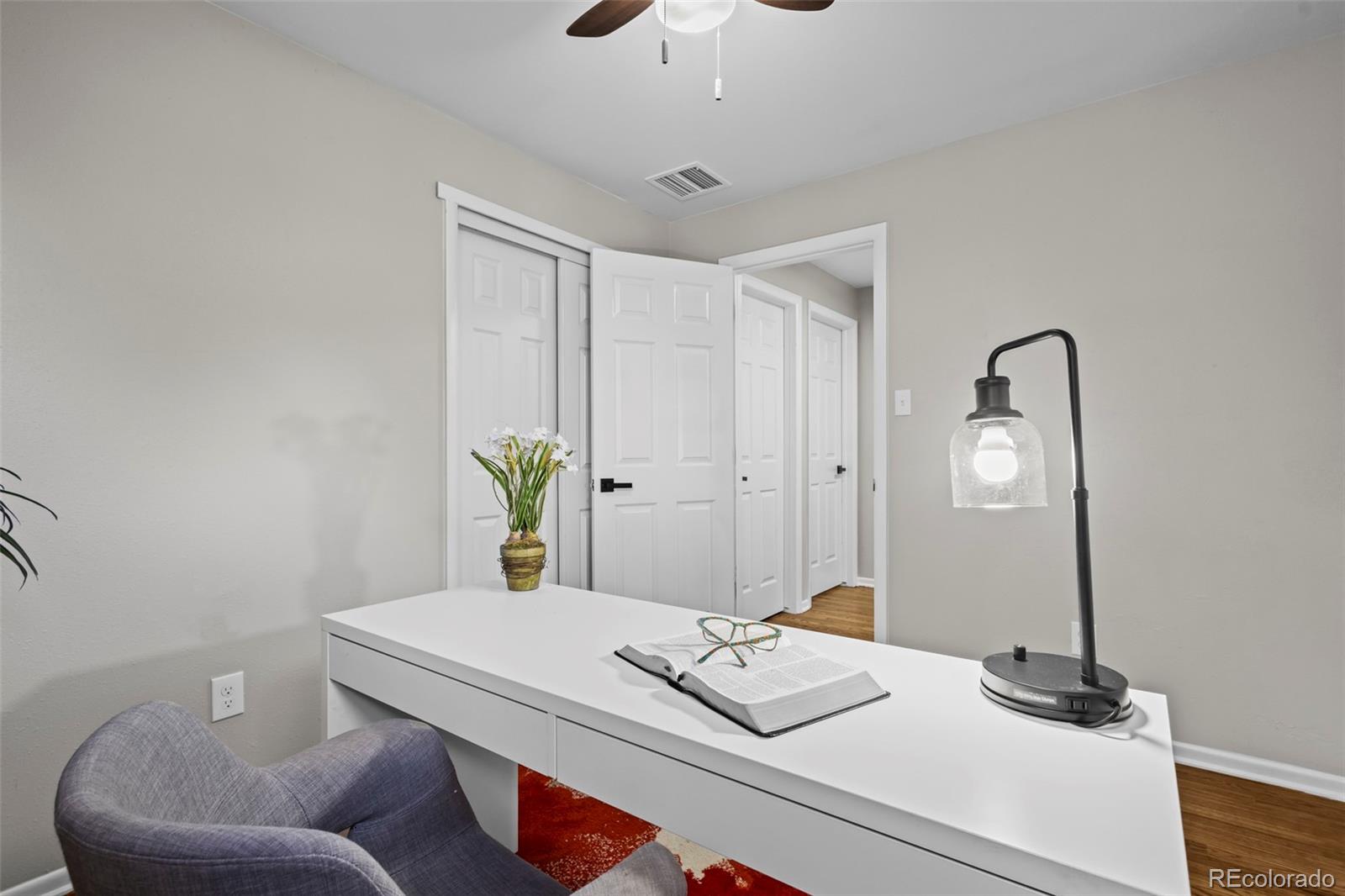 390 Scranton Street Aurora, CO 80011 - Photo 31 of 45 a bedroom with a bed and a table