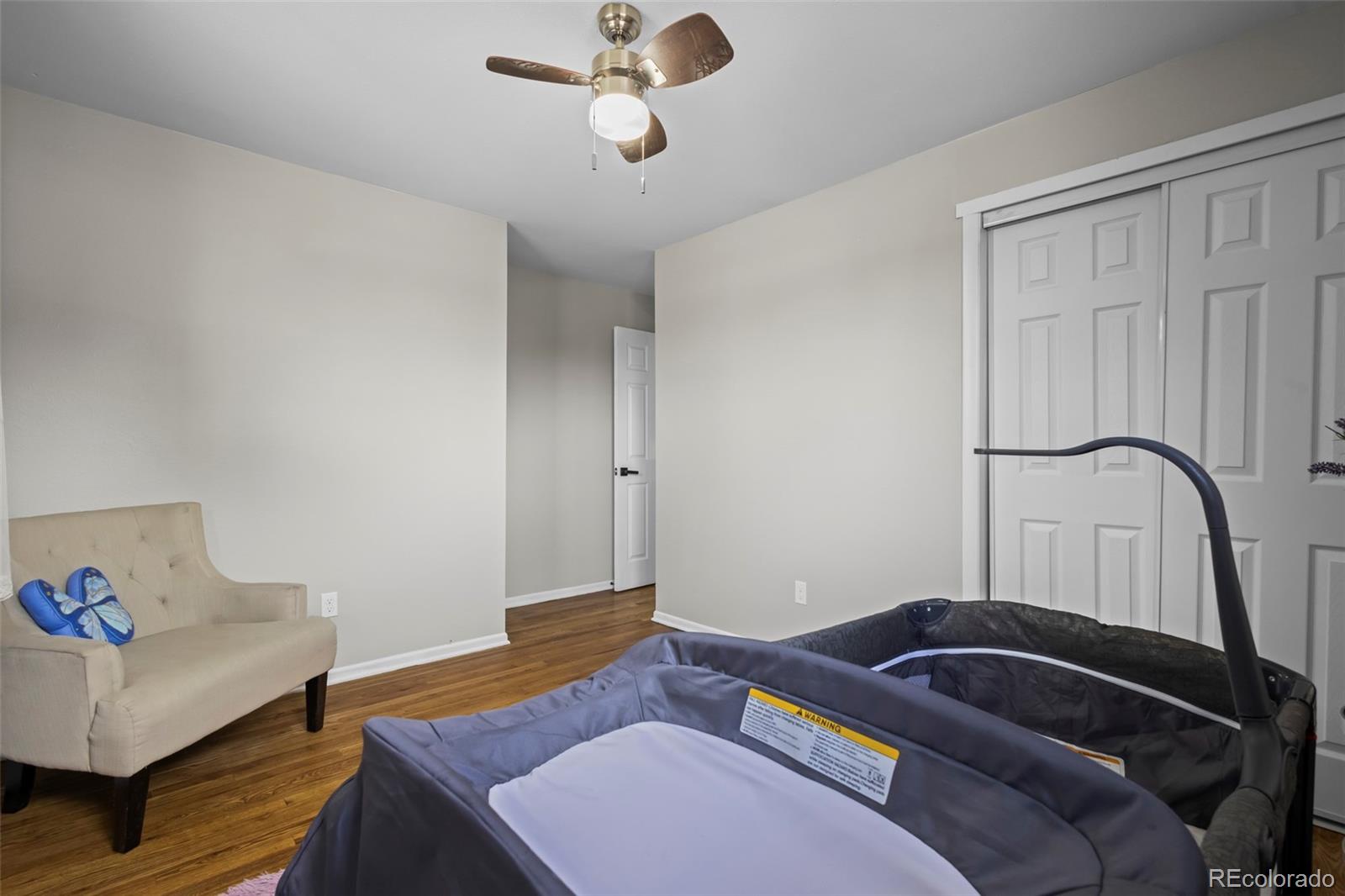 390 Scranton Street Aurora, CO 80011 - Photo 33 of 45 a bedroom with a bed and a dresser