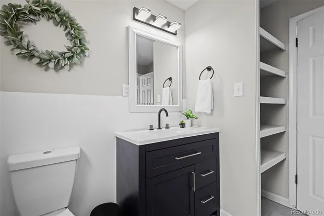 a bathroom with a toilet sink and mirror