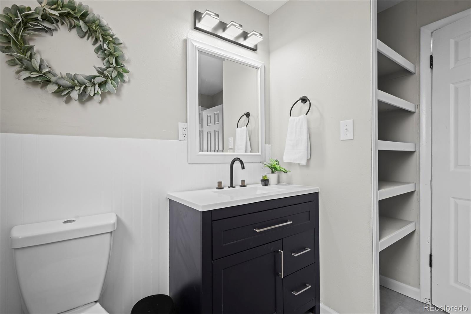 390 Scranton Street Aurora, CO 80011 - Photo 39 of 45 a bathroom with a toilet sink and mirror