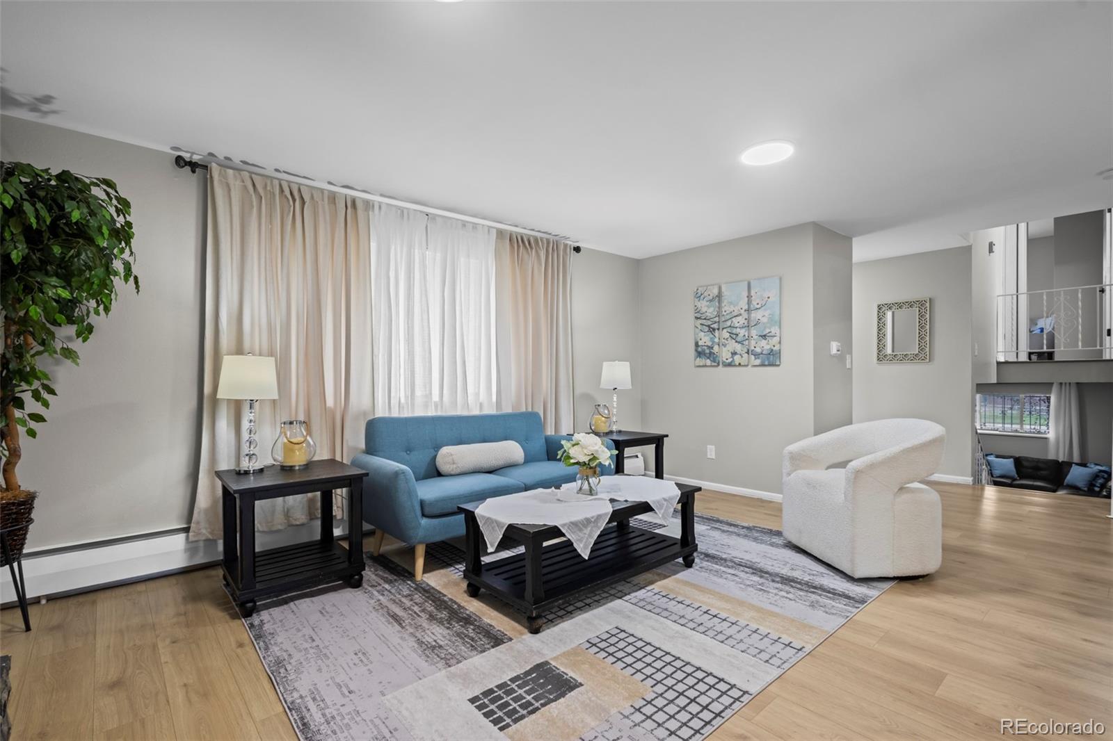 390 Scranton Street Aurora, CO 80011 - Photo 4 of 45 a living room with furniture and wooden floor