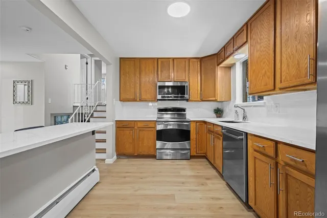 a kitchen with stainless steel appliances a stove sink and cabinets