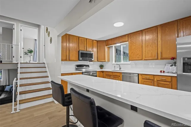 a kitchen with a refrigerator stove and sink