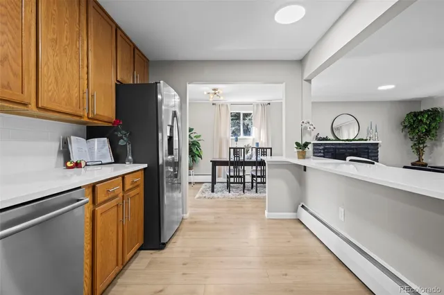 a kitchen with granite countertop a refrigerator stove top oven and sink