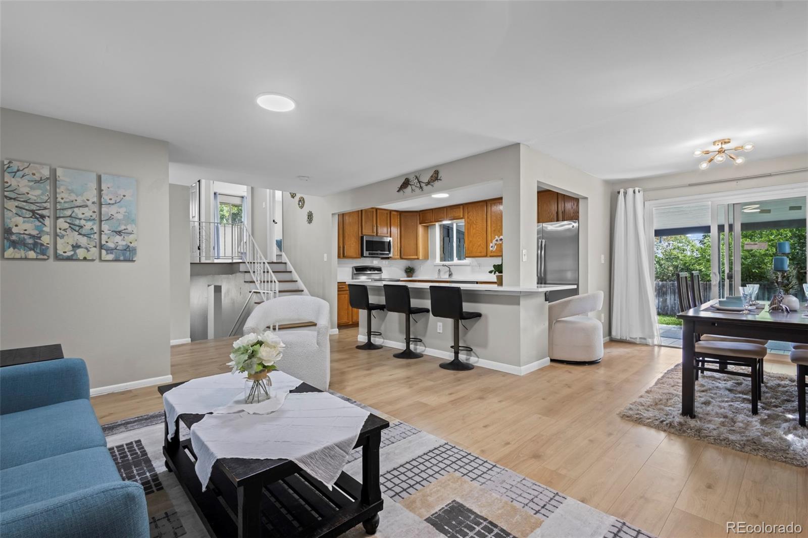 390 Scranton Street Aurora, CO 80011 - Photo 5 of 45 a living room with furniture and wooden floor