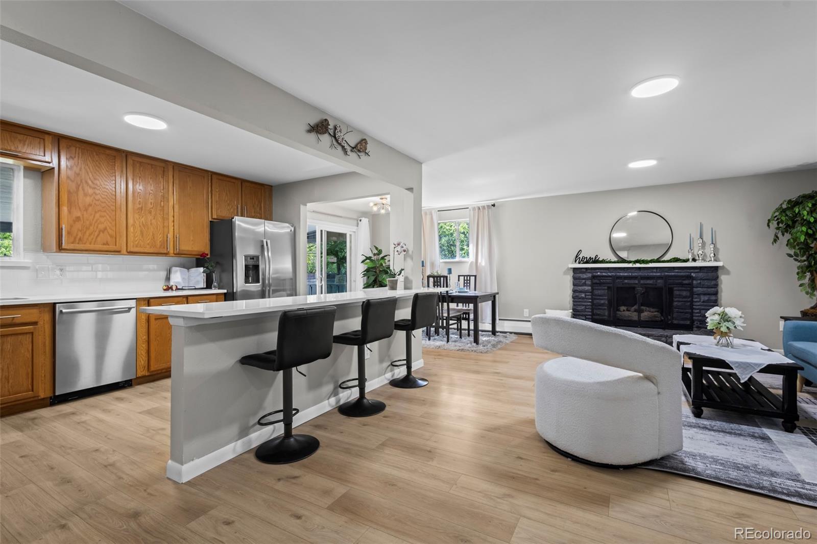 390 Scranton Street Aurora, CO 80011 - Photo 7 of 45 a living room with furniture and a fireplace