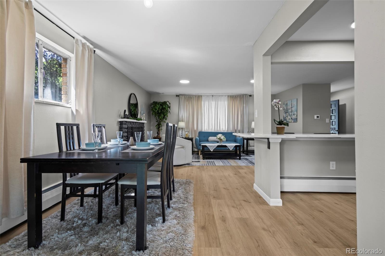 390 Scranton Street Aurora, CO 80011 - Photo 9 of 45 a view of a a dining room with furniture window and wooden floor