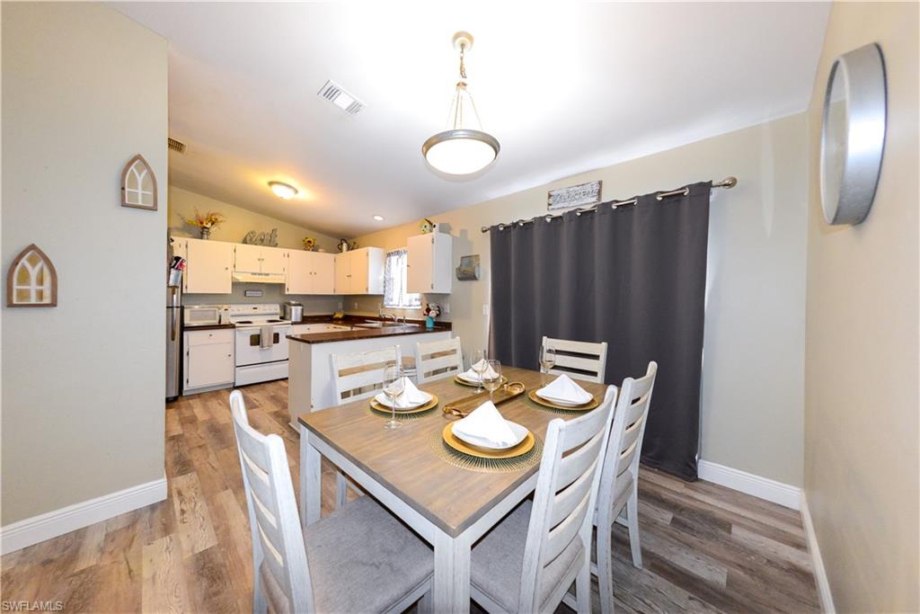 18347 Fuchsia Road Fort Myers, FL 33967 - Photo 14 of 35 a kitchen with a table and chairs in it