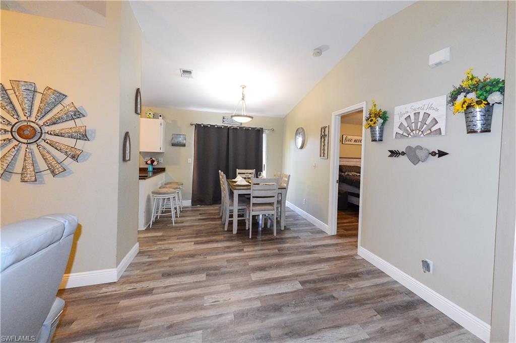 18347 Fuchsia Road Fort Myers, FL 33967 - Photo 17 of 35 a dining room with furniture and wooden floor