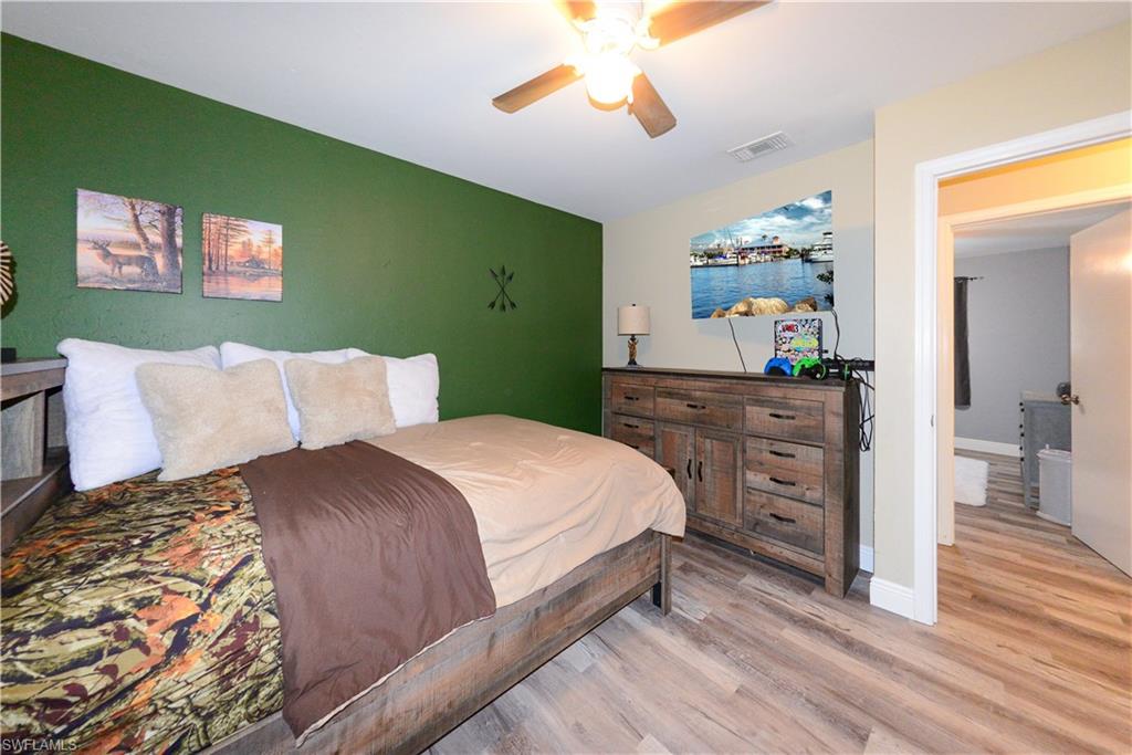 18347 Fuchsia Road Fort Myers, FL 33967 - Photo 19 of 35 a bedroom with a bed and a chandelier
