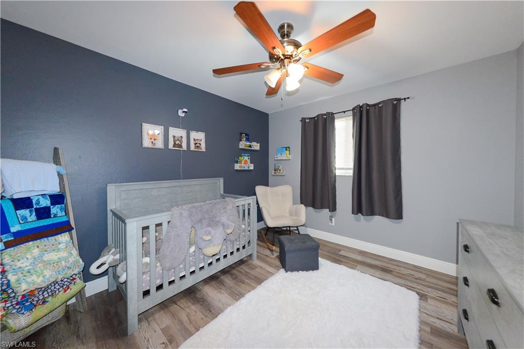 18347 Fuchsia Road Fort Myers, FL 33967 - Photo 22 of 35 a spacious bedroom with a bed and a chandelier