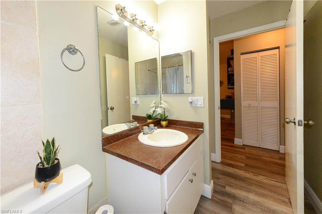 18347 Fuchsia Road Fort Myers, FL 33967 - Photo 24 of 35 a bathroom with a granite countertop sink and a mirror