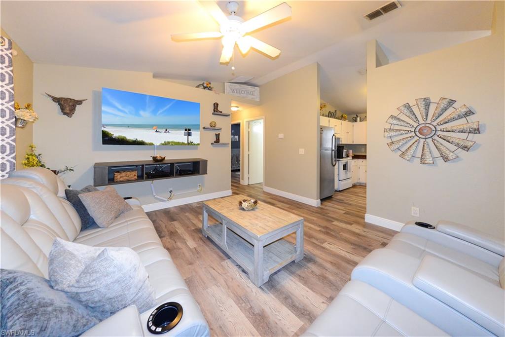 18347 Fuchsia Road Fort Myers, FL 33967 - Photo 27 of 35 a living room with furniture and a flat screen tv