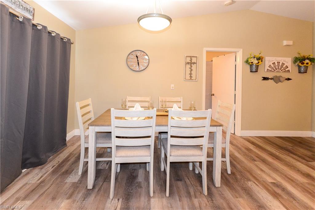 18347 Fuchsia Road Fort Myers, FL 33967 - Photo 28 of 35 a dining room with furniture and wooden floor