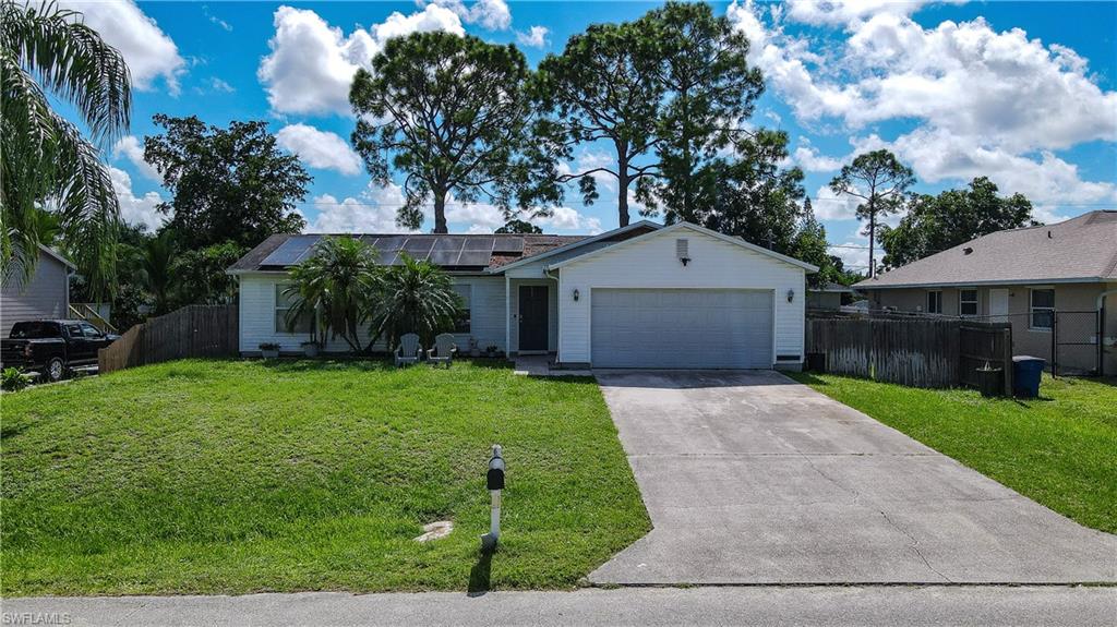 18347 Fuchsia Road Fort Myers, FL 33967 - Photo 30 of 35 a front view of a house with a yard and garage