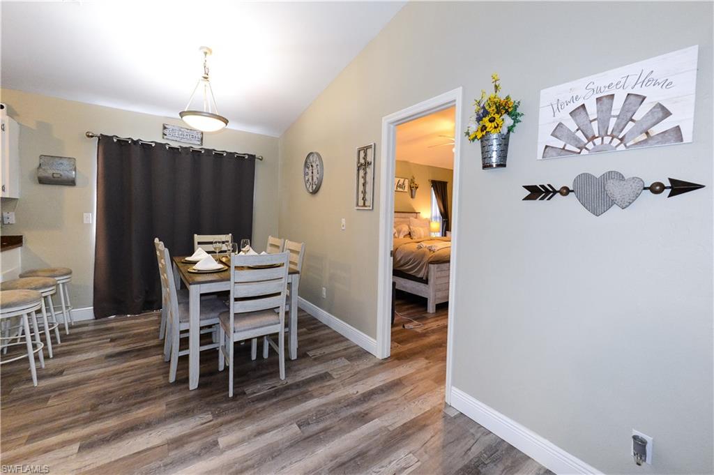 18347 Fuchsia Road Fort Myers, FL 33967 - Photo 4 of 35 a view of a dining room with furniture and wooden floor