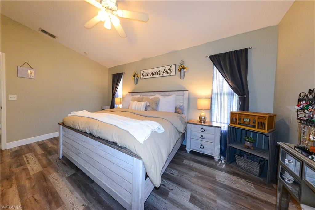 18347 Fuchsia Road Fort Myers, FL 33967 - Photo 6 of 35 a bedroom with a bed and wooden floor