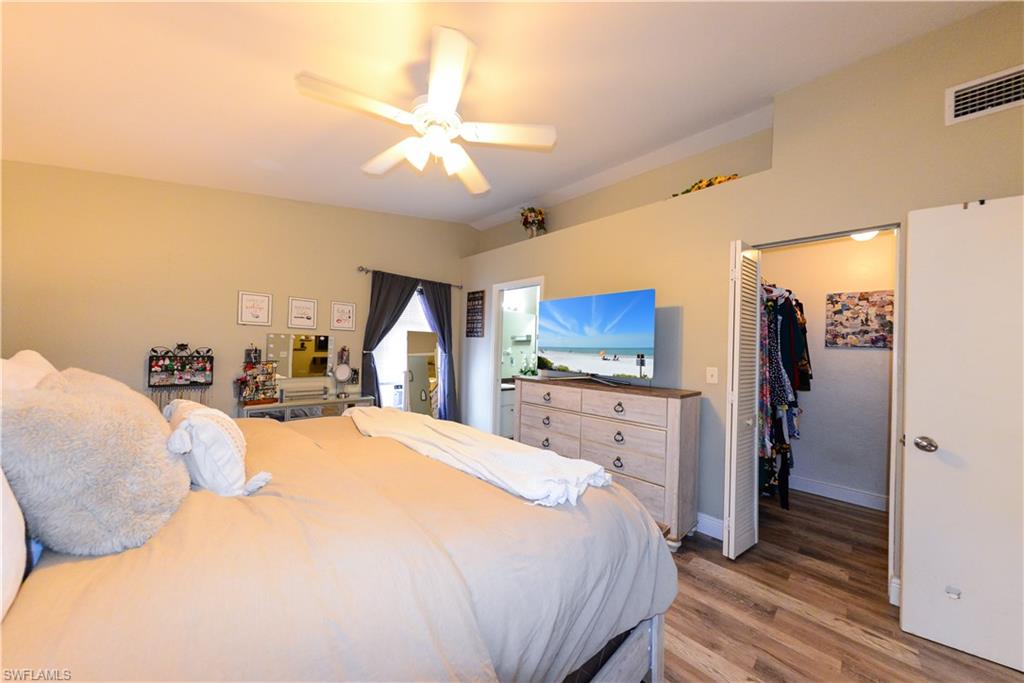 18347 Fuchsia Road Fort Myers, FL 33967 - Photo 7 of 35 a large bedroom with a bed and a flat screen tv