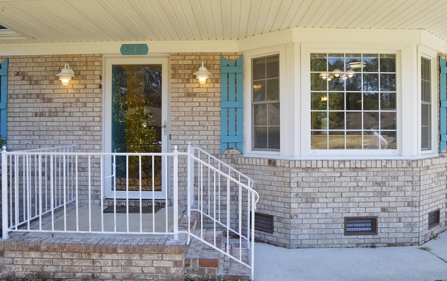 313 North Hampton Road Wilmington, NC 28409 - Photo 6 of 22 Lovely entry with white brick and bay window