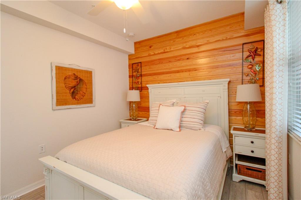 9554 Trevi Court, Unit 4737 Naples, FL 34113 - Photo 12 of 49 a bedroom with a bed and a painting on the wall