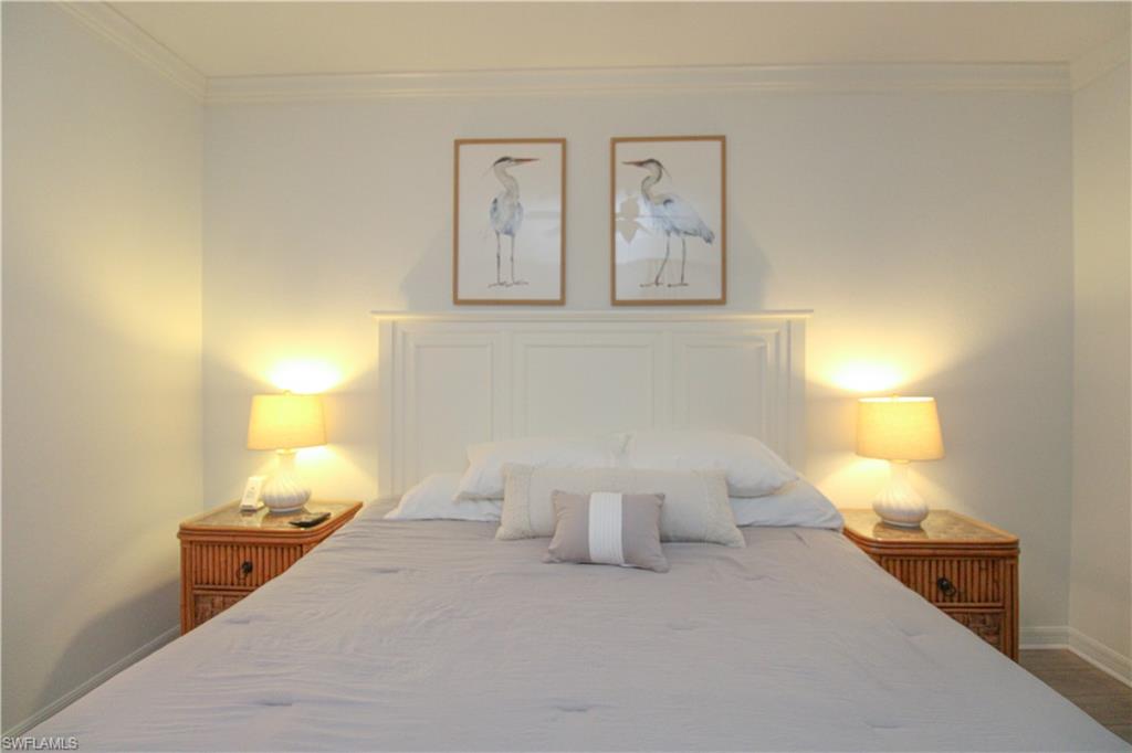 9554 Trevi Court, Unit 4737 Naples, FL 34113 - Photo 15 of 49 a bedroom with a bed and a lamp
