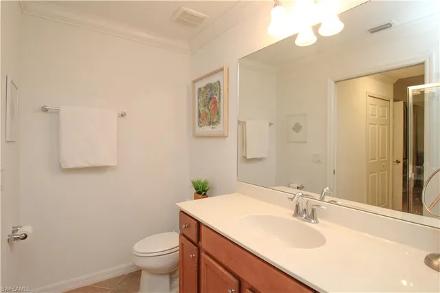 a bathroom with a granite countertop sink a mirror and shower