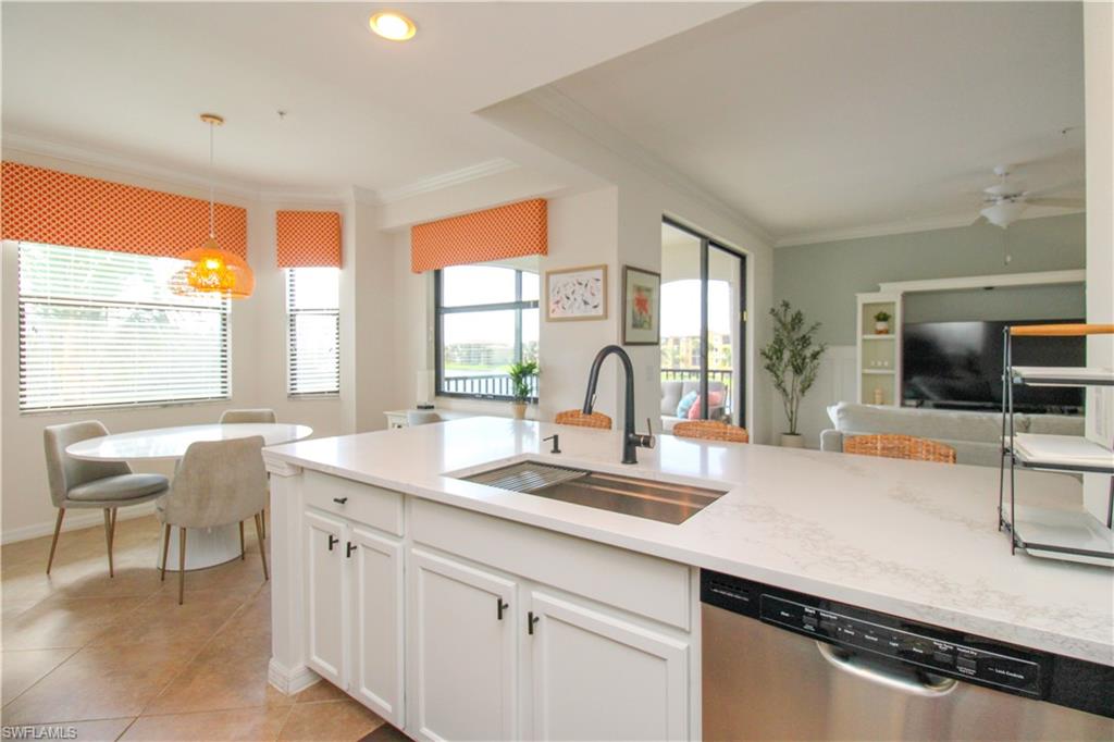 9554 Trevi Court, Unit 4737 Naples, FL 34113 - Photo 27 of 49 a kitchen with a sink and a large window