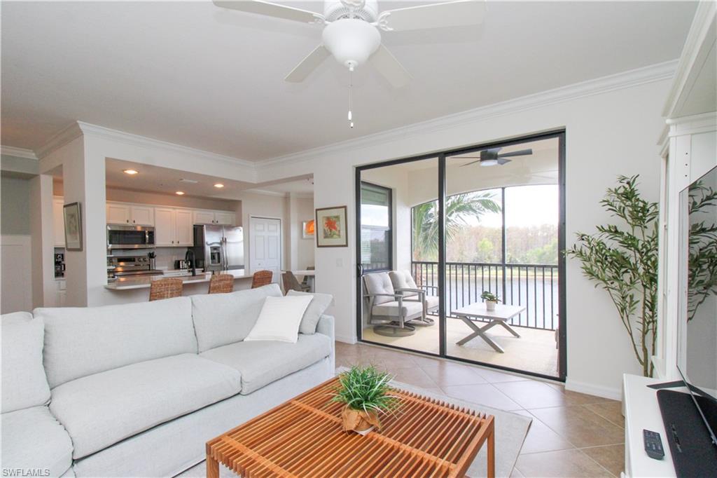 9554 Trevi Court, Unit 4737 Naples, FL 34113 - Photo 31 of 49 a living room with furniture and a large window