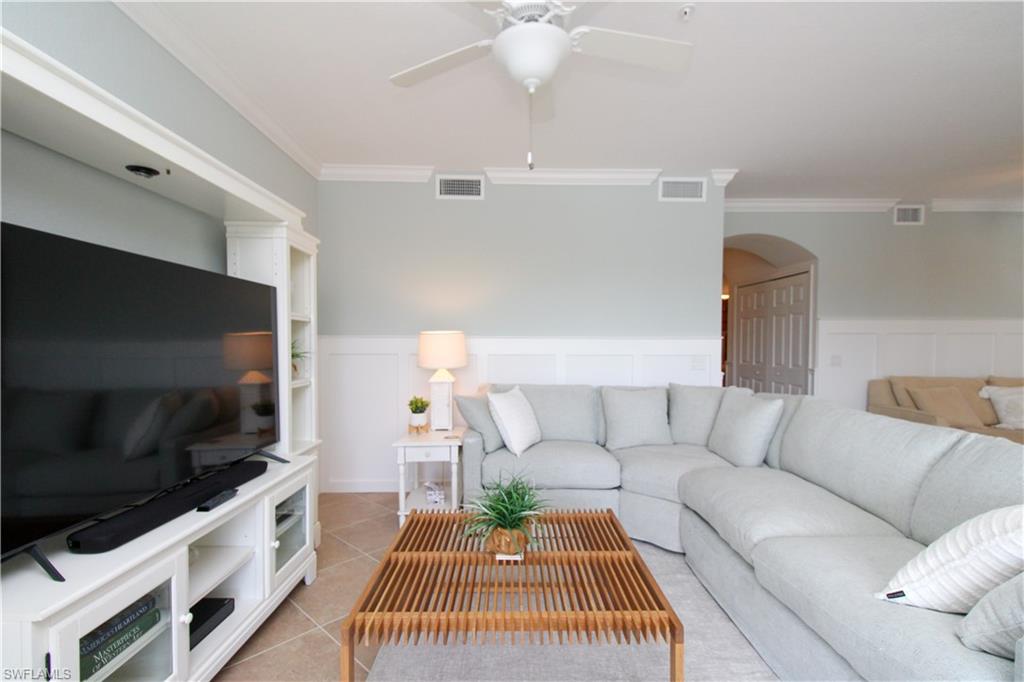 9554 Trevi Court, Unit 4737 Naples, FL 34113 - Photo 32 of 49 a living room with furniture and a flat screen tv