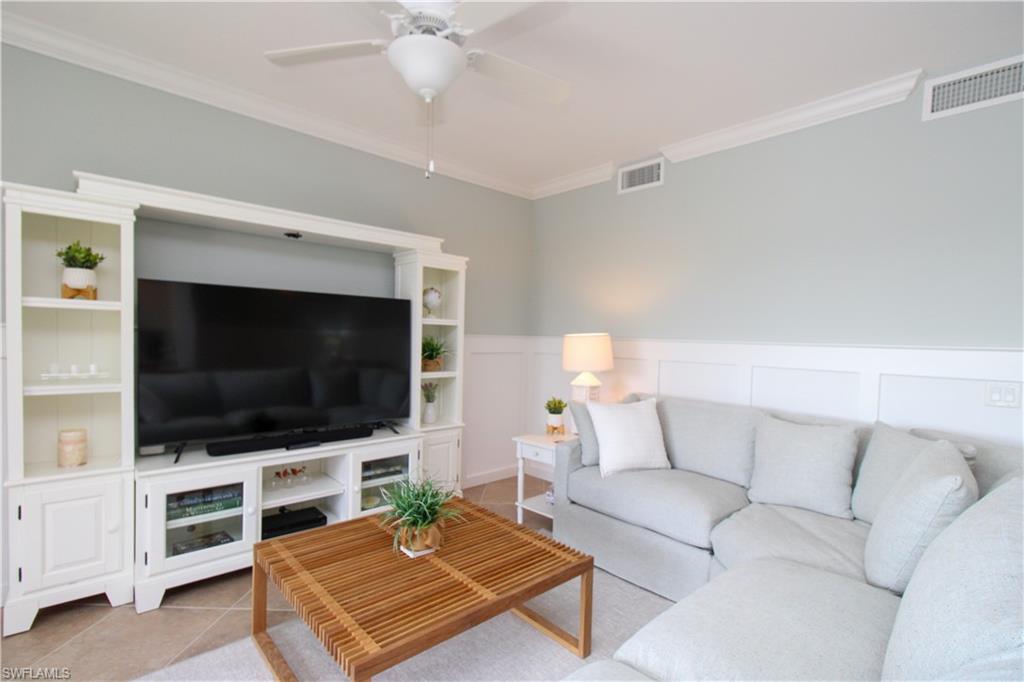 9554 Trevi Court, Unit 4737 Naples, FL 34113 - Photo 33 of 49 a living room with furniture and a flat screen tv