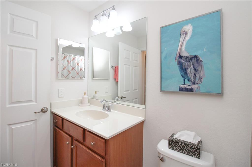 9554 Trevi Court, Unit 4737 Naples, FL 34113 - Photo 9 of 49 a bathroom with a sink a vanity and a mirror