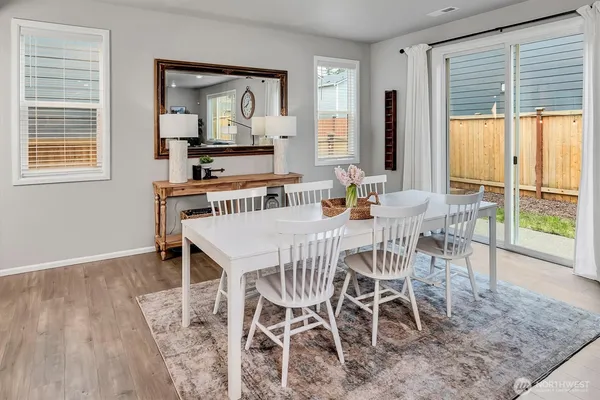 a dining room with furniture and wooden floor