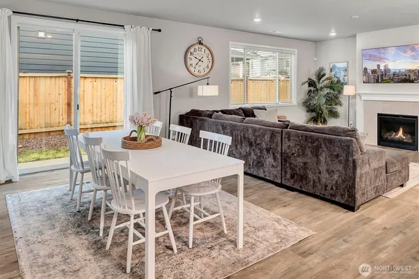 a living room with furniture a large window and a fireplace