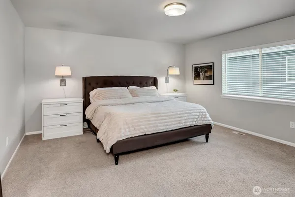 a bedroom with a bed and a night stand